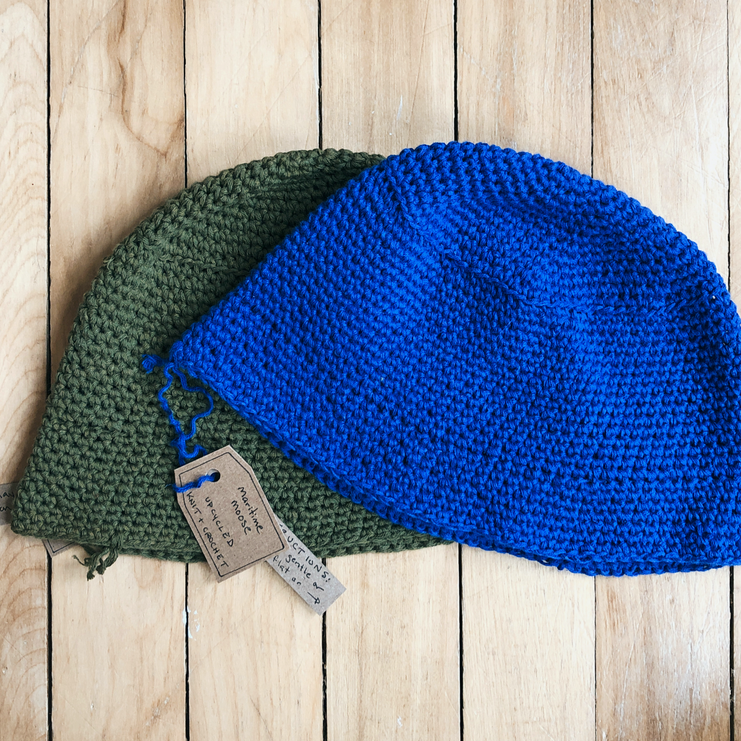 Two youth sized bucket hats made from repurposed materials. Green khaki coloured upcycled cotton and bright blue upcycled cotton made into cute little kiddo bucket hats.