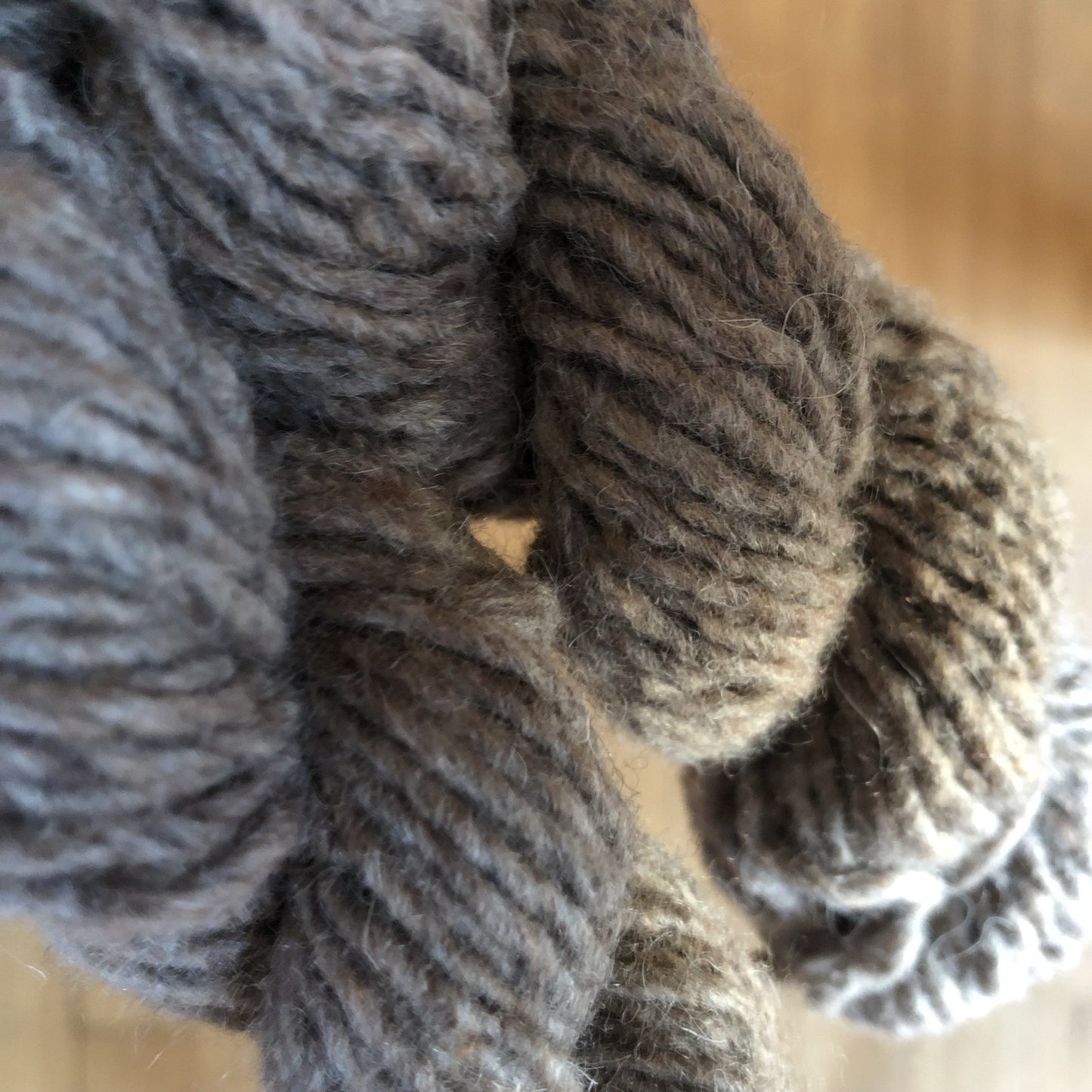 Up close shot of the thick beige woolen yarn.