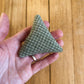 light green and white plaid triangle shaped catnip toy.