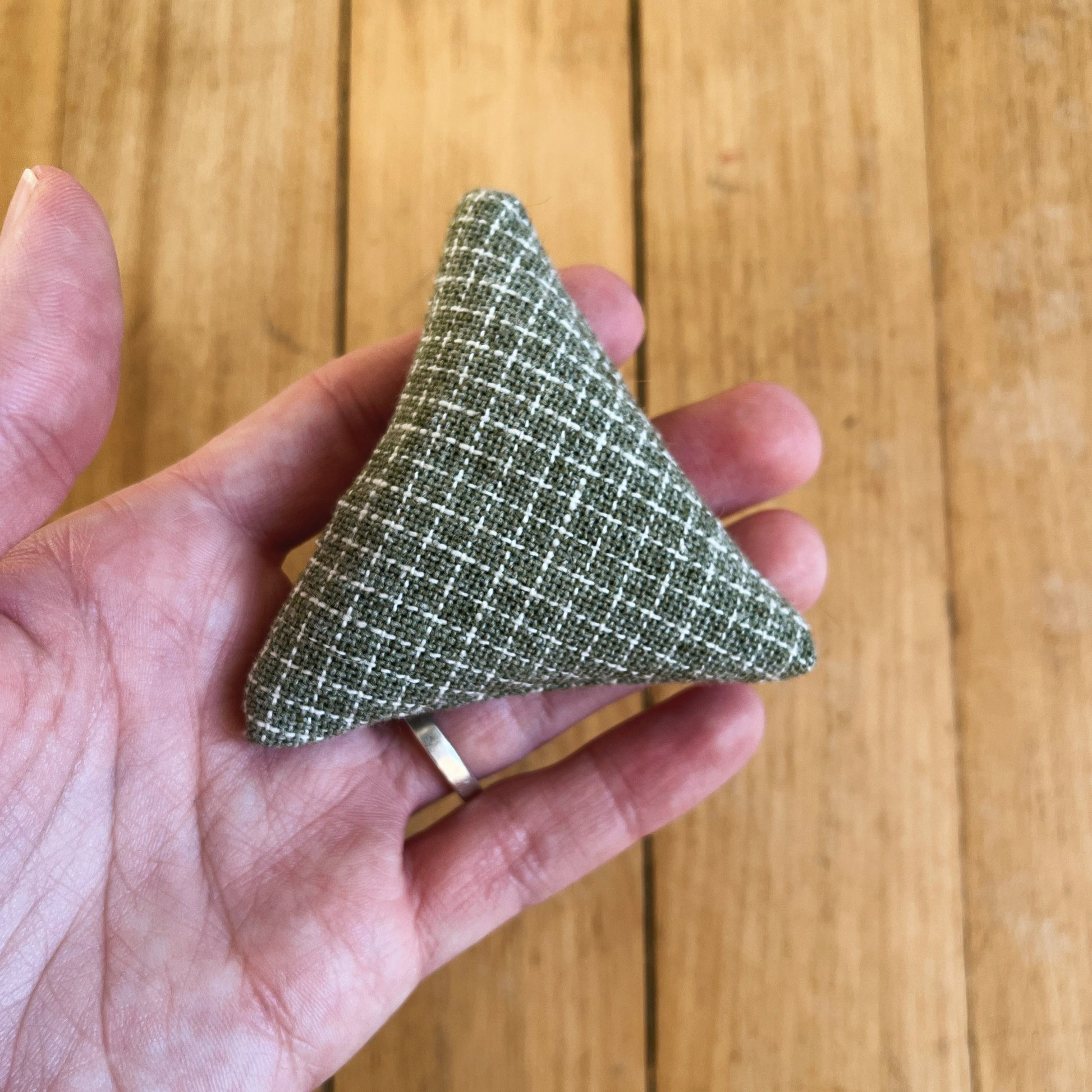 light green and white plaid triangle shaped catnip toy.