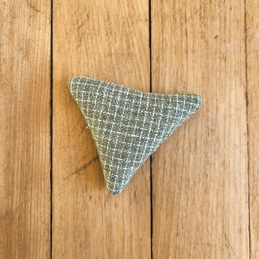 light green and white checkered/plaid patterned catnip toy in a triangle shape.